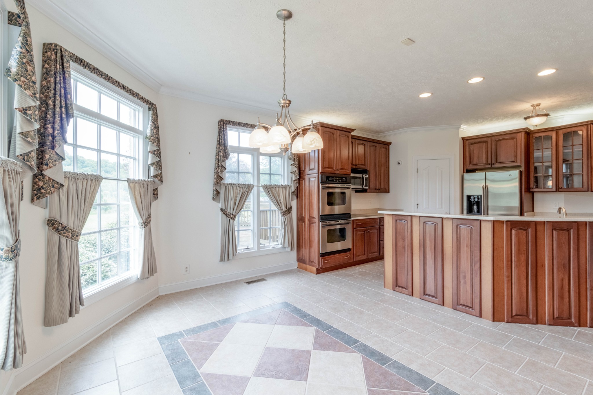 563 Pond Apple Road Clarksville, TN 37043 - Photo 11 of 39 a open kitchen with stainless steel appliances granite countertop a refrigerator oven a sink with dishwasher and white cabinets with wooden floor