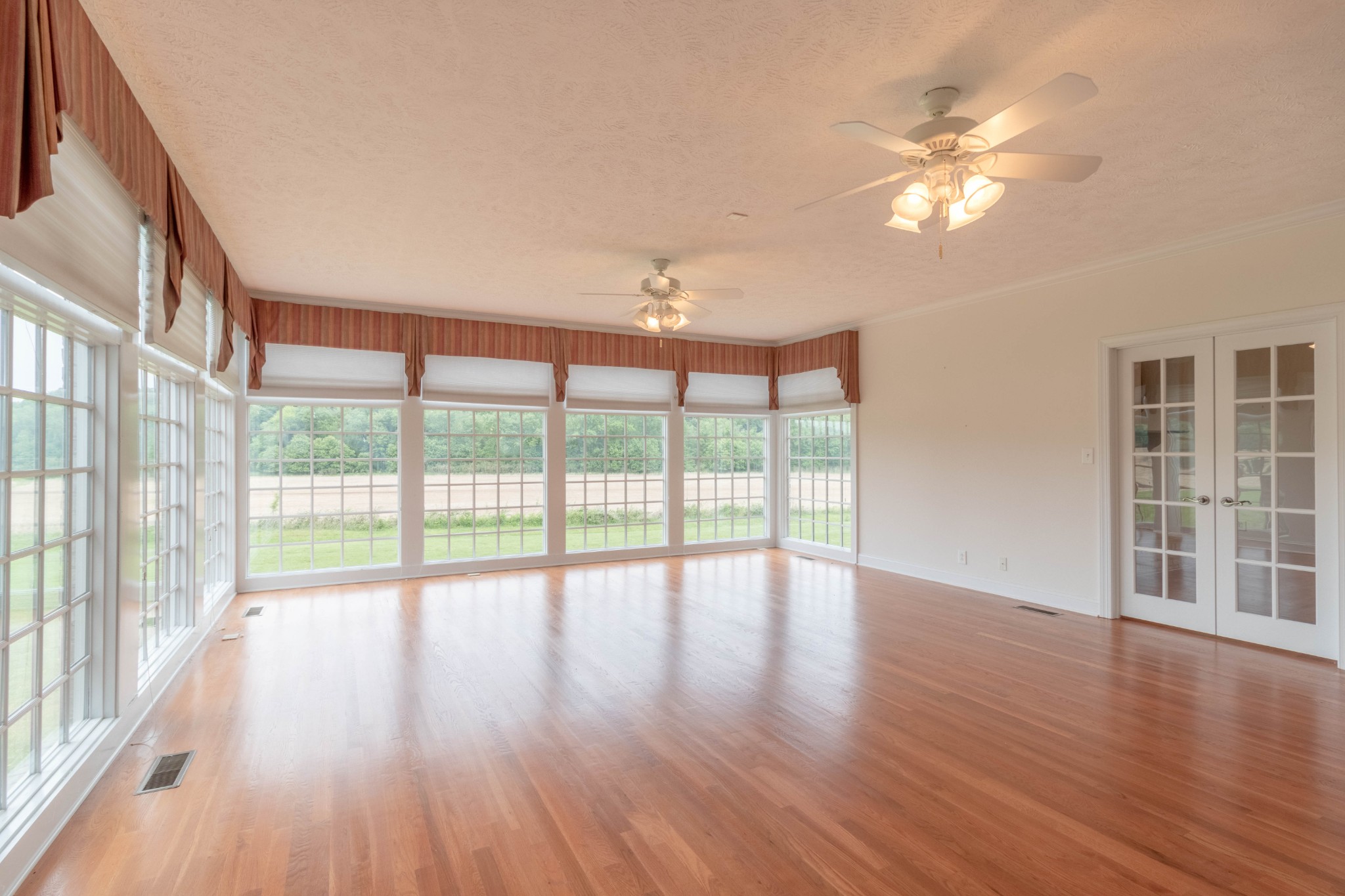 563 Pond Apple Road Clarksville, TN 37043 - Photo 14 of 39 a view of an empty room with wooden floor and a window