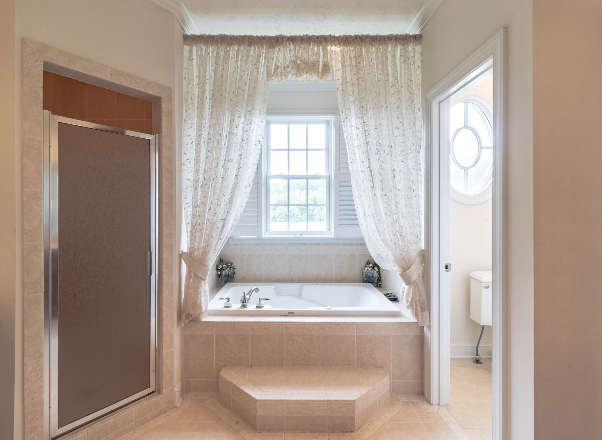563 Pond Apple Road Clarksville, TN 37043 - Photo 21 of 39 a bath tub sitting in a bathroom next to a window