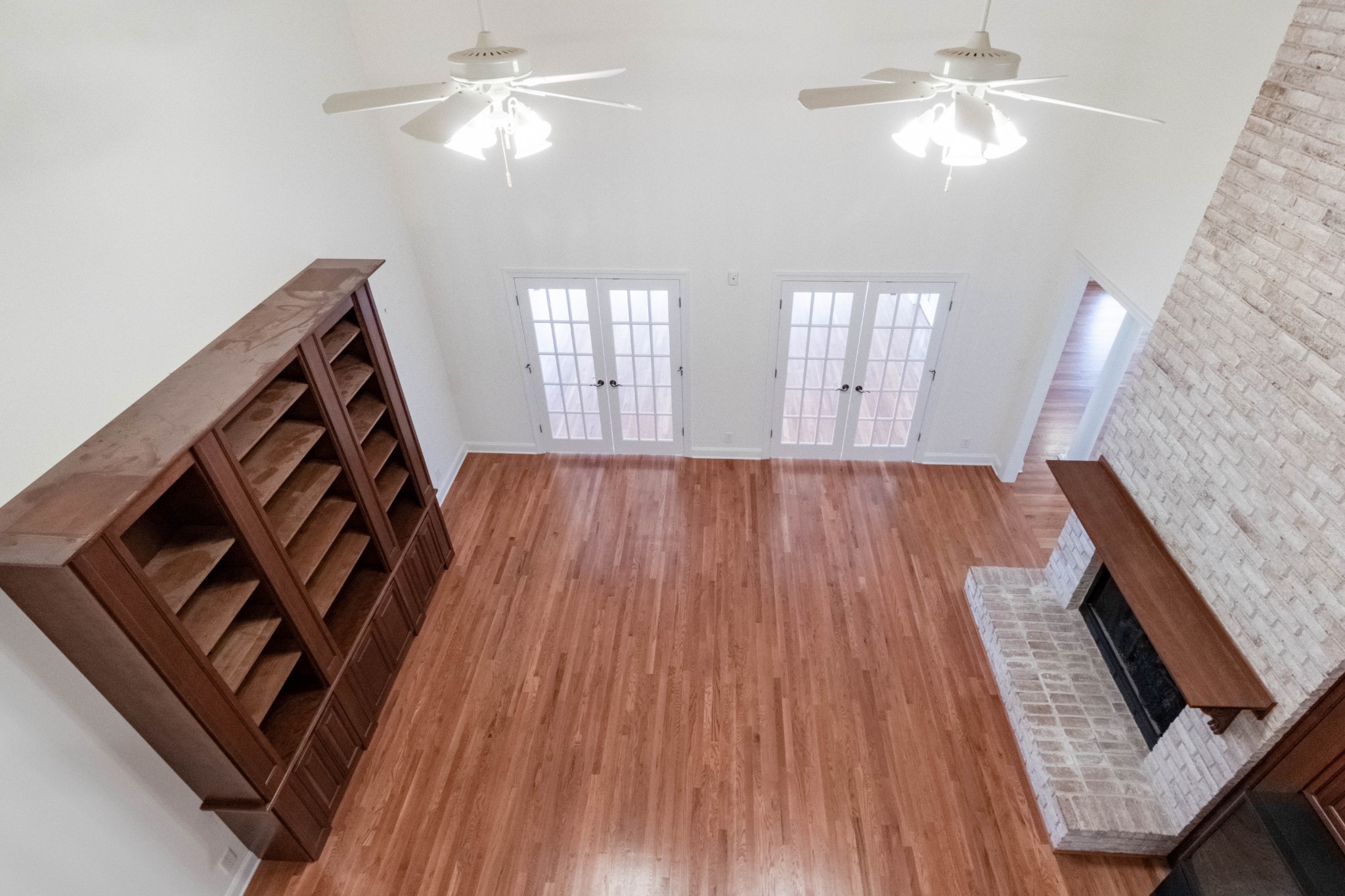 563 Pond Apple Road Clarksville, TN 37043 - Photo 30 of 39 a view of an empty room wooden floor and a ceiling fan