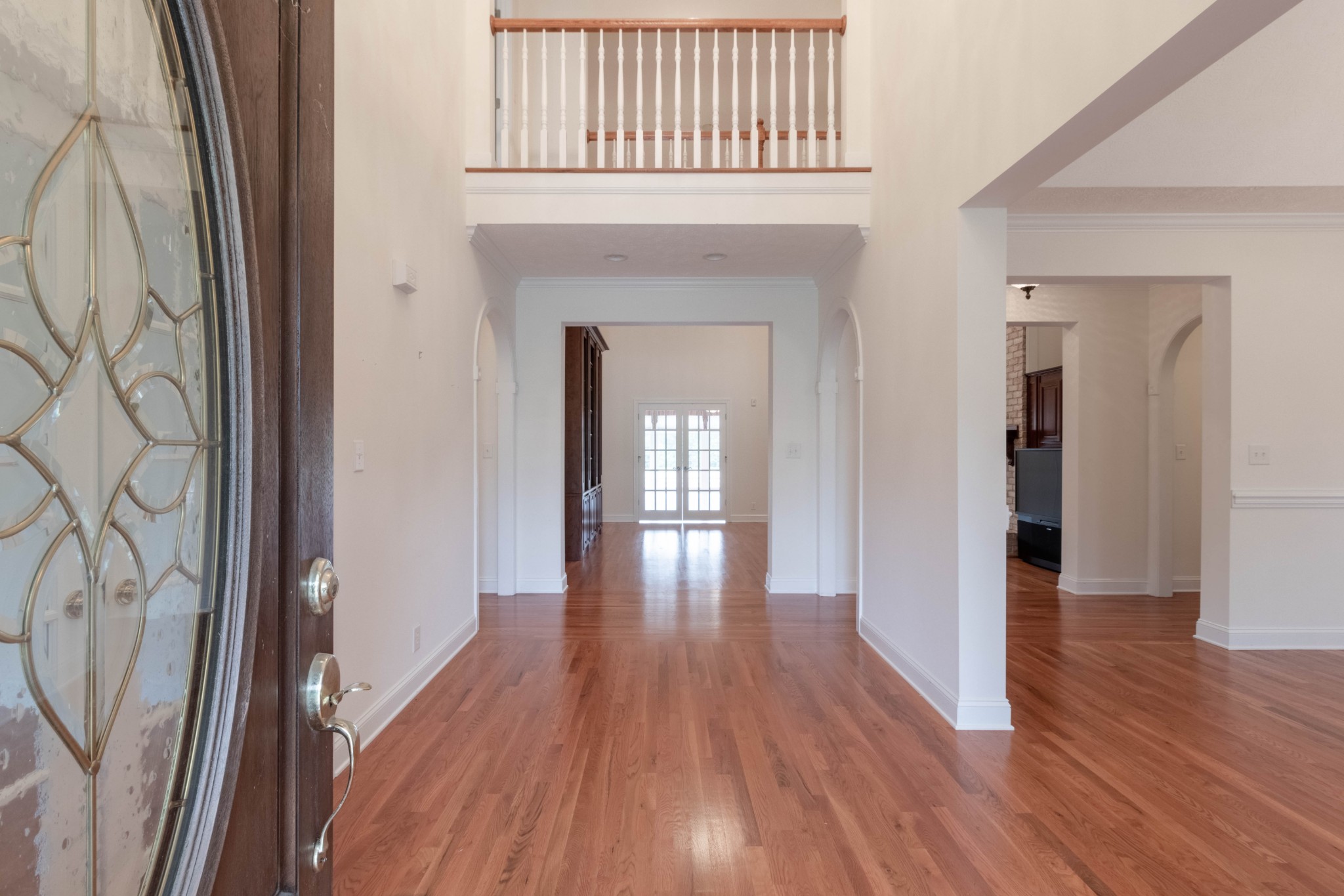 563 Pond Apple Road Clarksville, TN 37043 - Photo 4 of 39 a view of a hallway with wooden floor and staircase