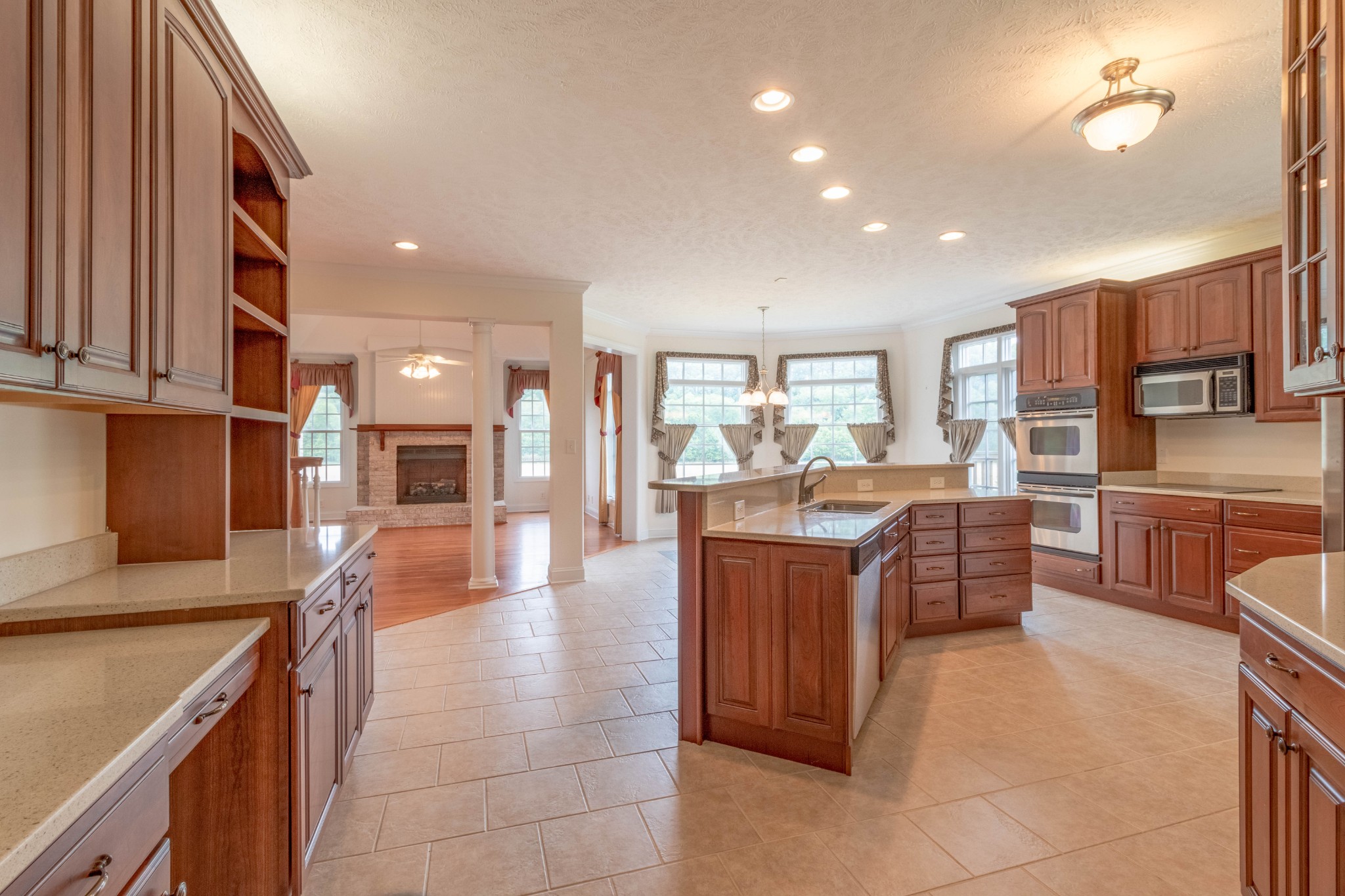 563 Pond Apple Road Clarksville, TN 37043 - Photo 10 of 39 a open kitchen with granite countertop a stove top oven a sink a dining table and chairs