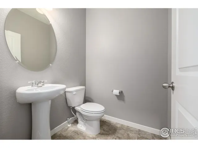 a bathroom with a sink toilet and a mirror