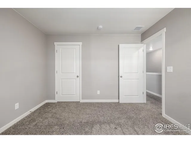 an empty room with closet area