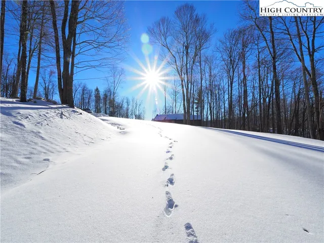 a view of wooden fence and a trees