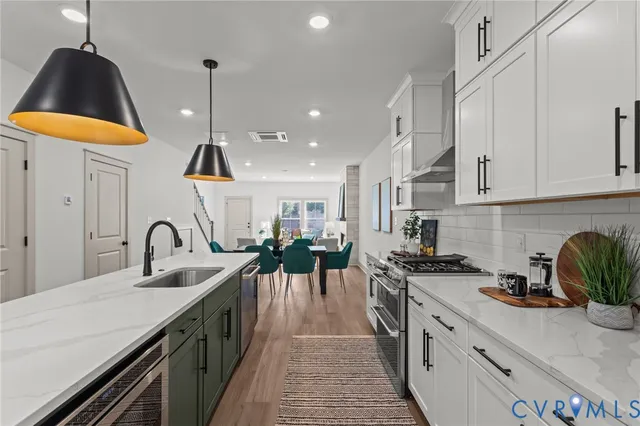 a kitchen with a sink a stove and cabinets