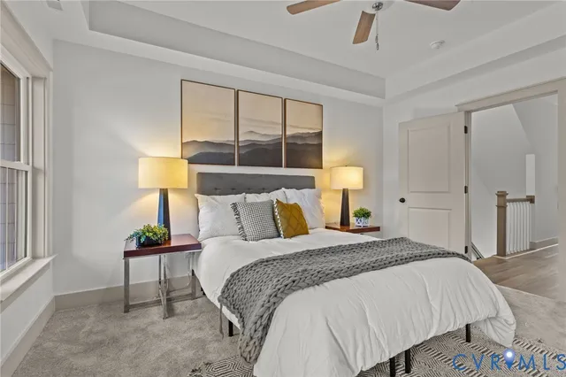 a bedroom with a bed lamps and a window