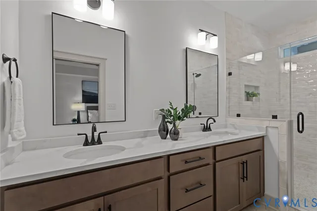 a bathroom with a sink double vanity granite and a mirror