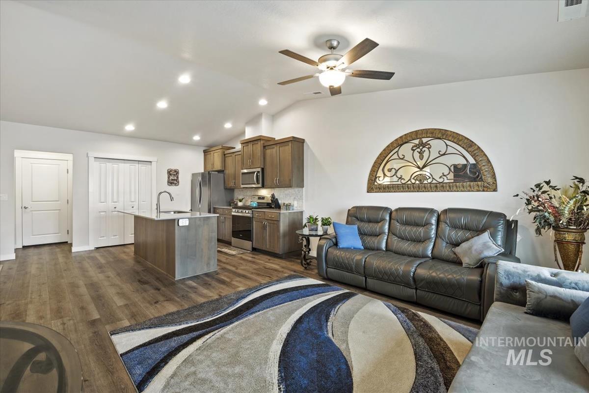 193 West Haniken Street Meridian, ID 83642 - Photo 11 of 27 Living room with dark wood-type flooring, lofted ceiling, a ceiling fan, and recessed lighting
