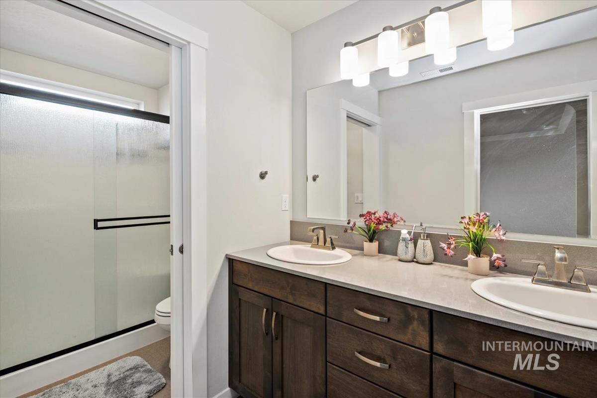 193 West Haniken Street Meridian, ID 83642 - Photo 17 of 27 Bathroom featuring a shower stall and double vanity