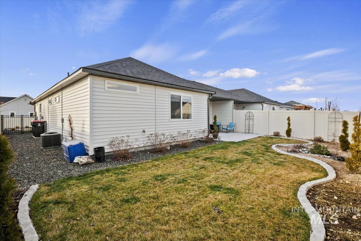 193 West Haniken Street Meridian, ID 83642 - Photo 21 of 27 Rear view of house with a fenced backyard, a patio area, and a shingled roof