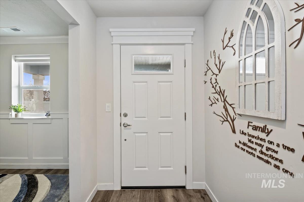 193 West Haniken Street Meridian, ID 83642 - Photo 3 of 27 Entrance foyer featuring dark wood-type flooring and wainscoting