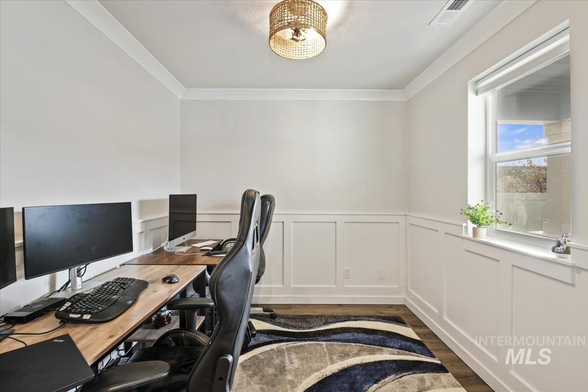 193 West Haniken Street Meridian, ID 83642 - Photo 4 of 27 Office with a wainscoted wall, dark wood-style flooring, a decorative wall, and ornamental molding