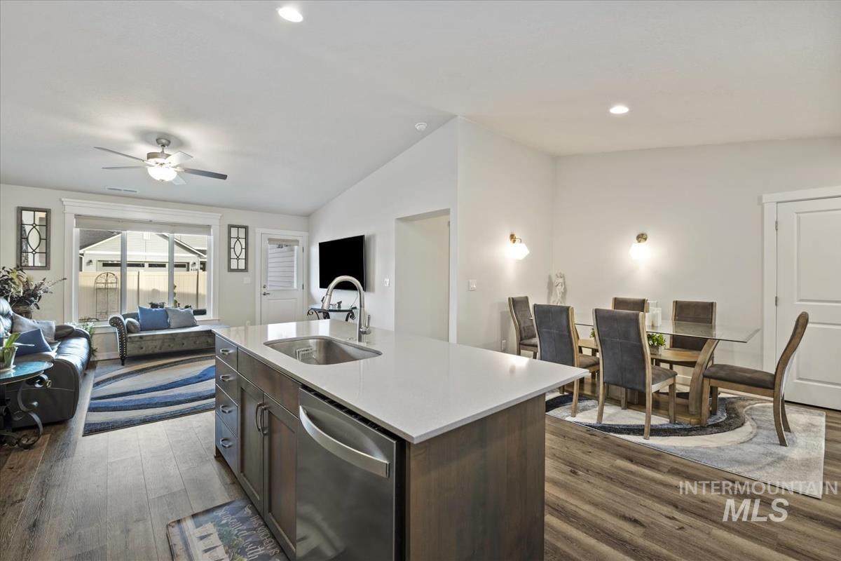 193 West Haniken Street Meridian, ID 83642 - Photo 27 of 27 Kitchen with open floor plan, dark wood-style flooring, dishwasher, dark wood finish cabinetry, and lofted ceiling