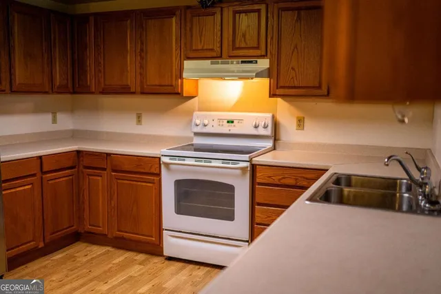 a kitchen with sink and cabinets