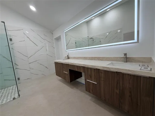 a bathroom with a double vanity sink and a mirror