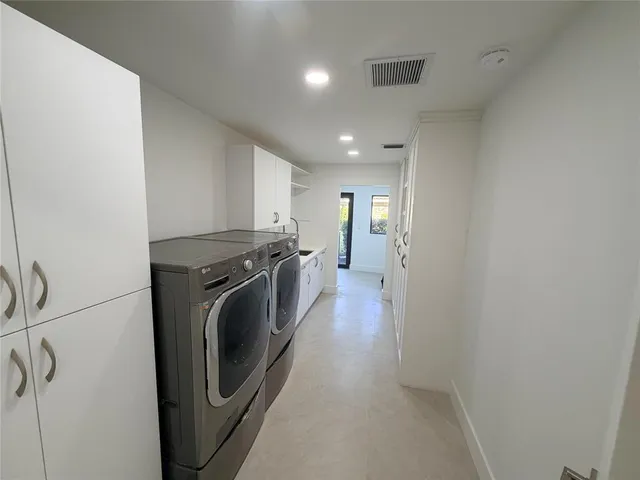 a kitchen with stainless steel appliances a refrigerator and a stove