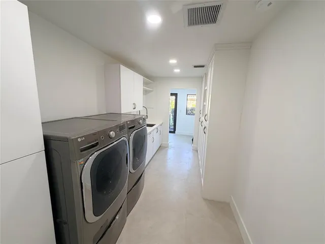 a view of a storage and utility room with washer and dryer