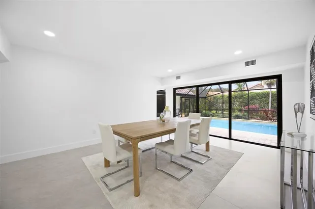 an aerial view of residential houses with outdoor space and trees all around