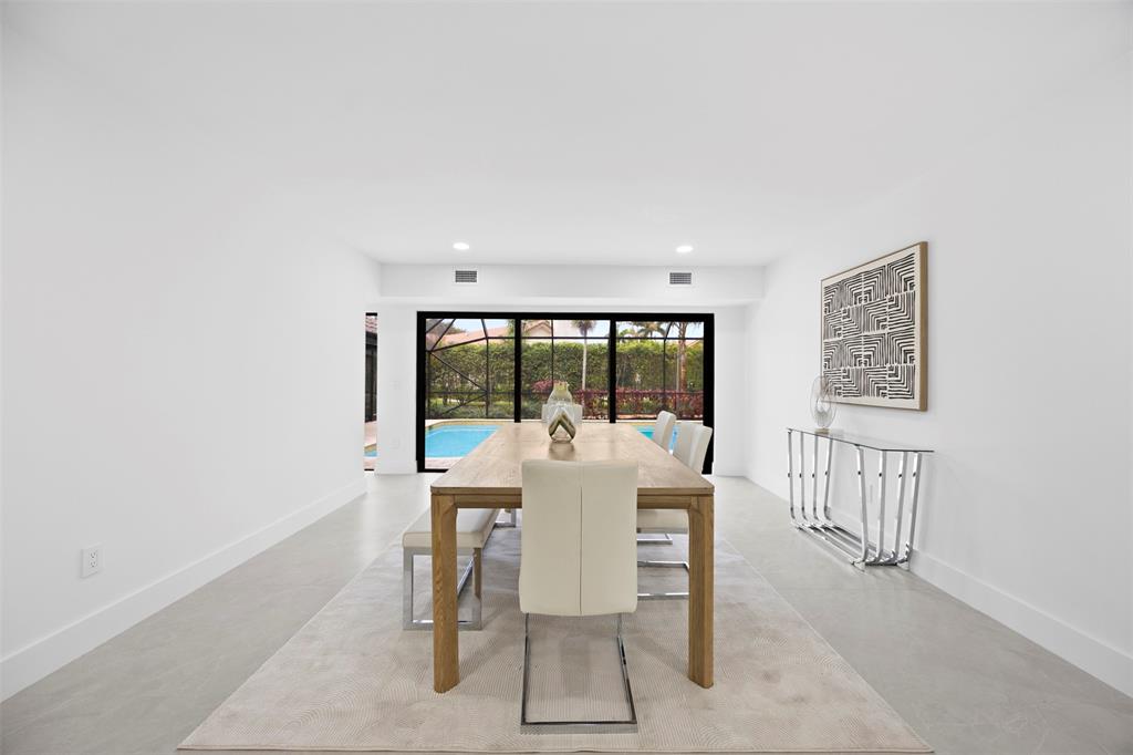 7571 Estrella Circle Boca Raton, FL 33433 - Photo 24 of 76 a dining room with furniture a rug and a large window