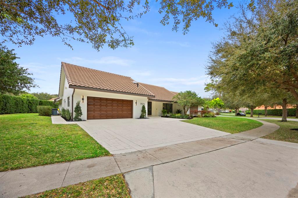 7571 Estrella Circle Boca Raton, FL 33433 - Photo 64 of 76 a front view of a house with yard and green space
