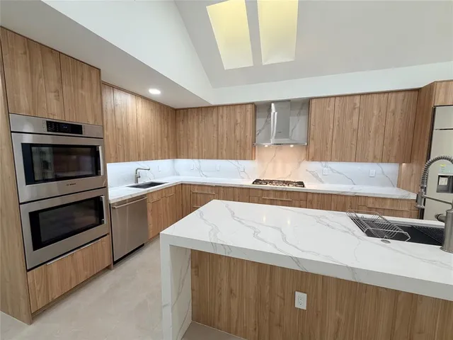 a kitchen with a sink a stove and cabinets