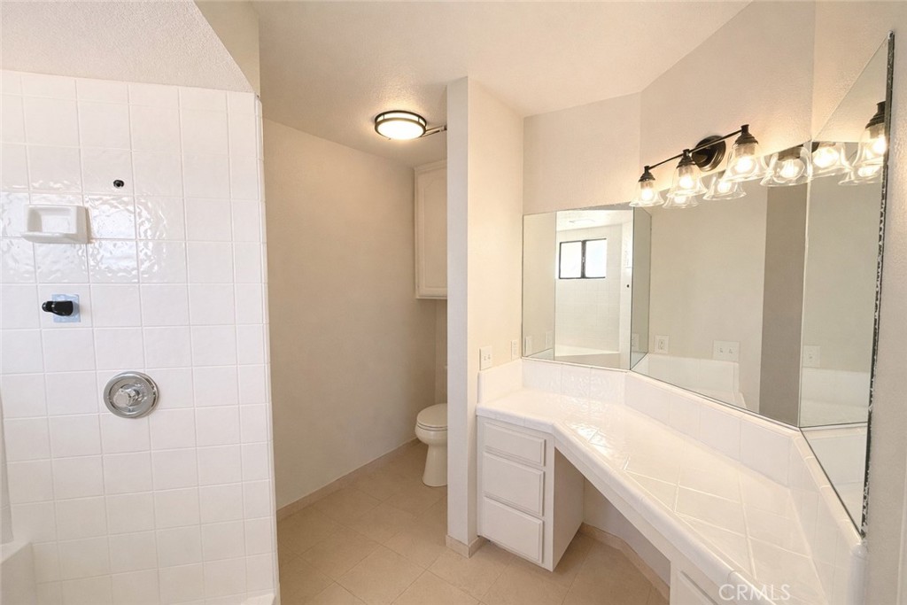 14890 Apple Valley Road Apple Valley, CA 92307 - Photo 11 of 28 a bathroom with a tub sink and mirror