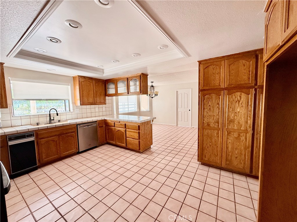 14890 Apple Valley Road Apple Valley, CA 92307 - Photo 13 of 28 a kitchen with stainless steel appliances a sink and a refrigerator