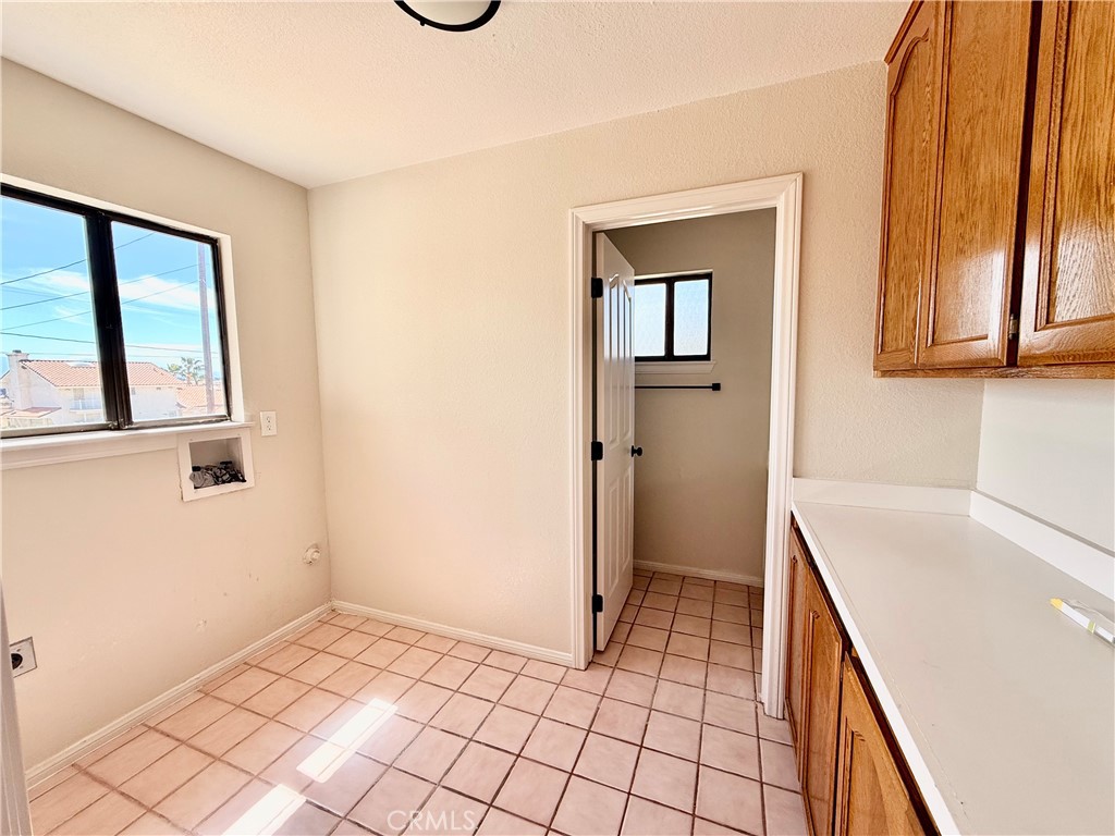 14890 Apple Valley Road Apple Valley, CA 92307 - Photo 17 of 28 a view of a kitchen and a sink and dishwasher with wooden floor