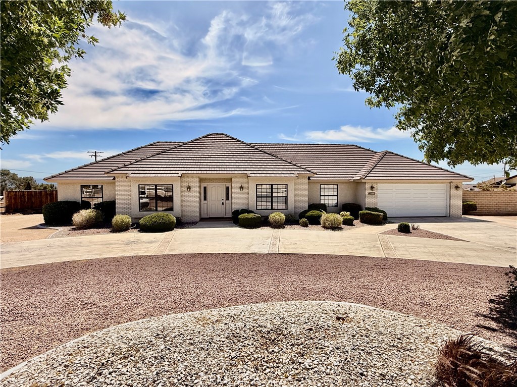 14890 Apple Valley Road Apple Valley, CA 92307 - Photo 2 of 28 a front view of a house with a yard