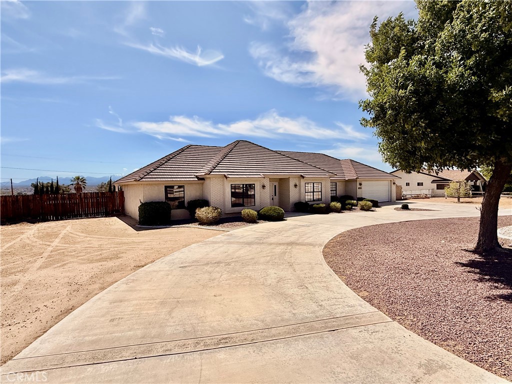 14890 Apple Valley Road Apple Valley, CA 92307 - Photo 27 of 28 a front view of a house with a yard