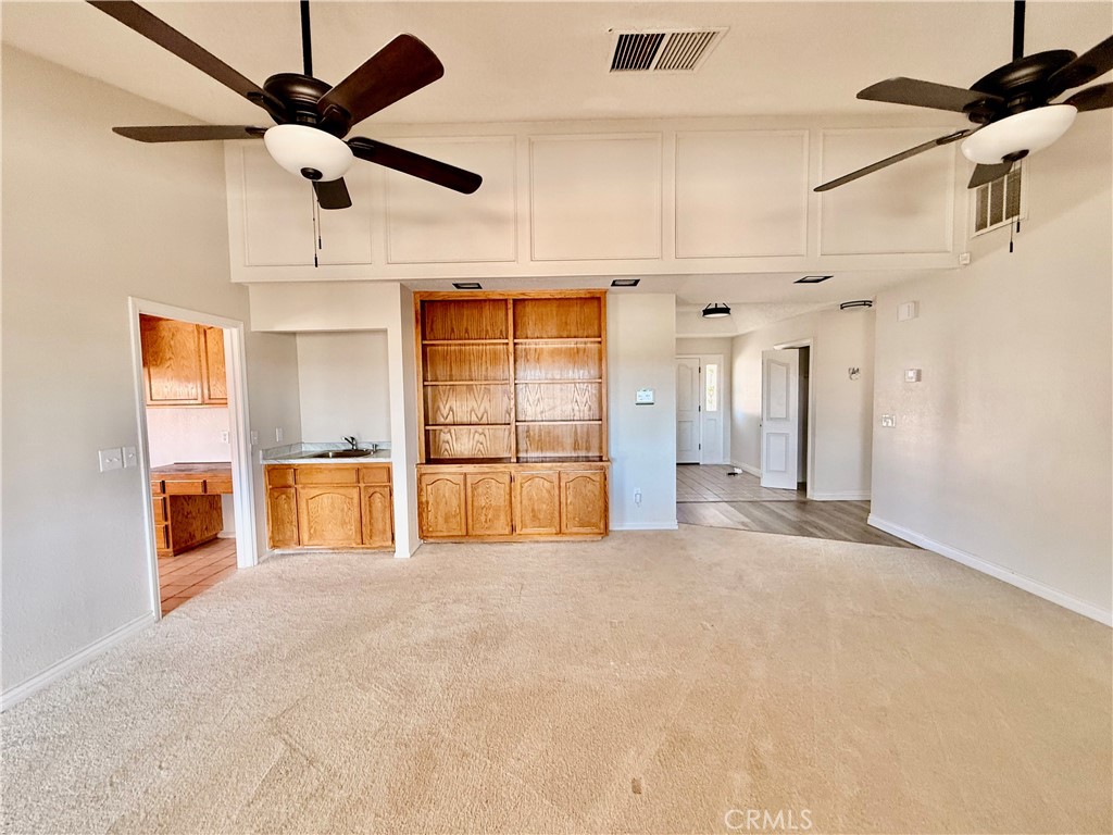 14890 Apple Valley Road Apple Valley, CA 92307 - Photo 8 of 28 a view of an empty room with a ceiling fan