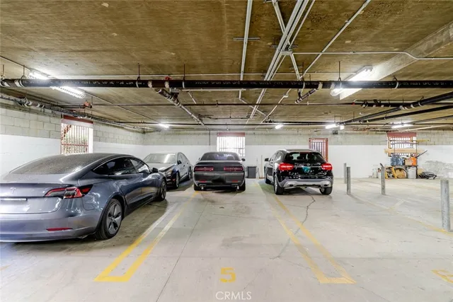 a view of parking garage with cars parked