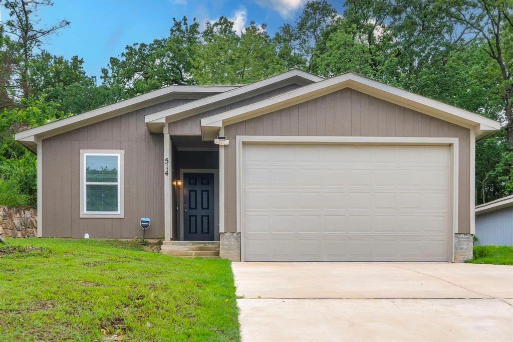 a view of wooden house with a yard