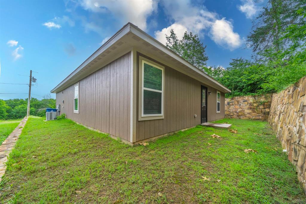 514 East Shepherd Street Denison, TX 75021 - Photo 14 of 16 a view of backyard with potted plants and large tree