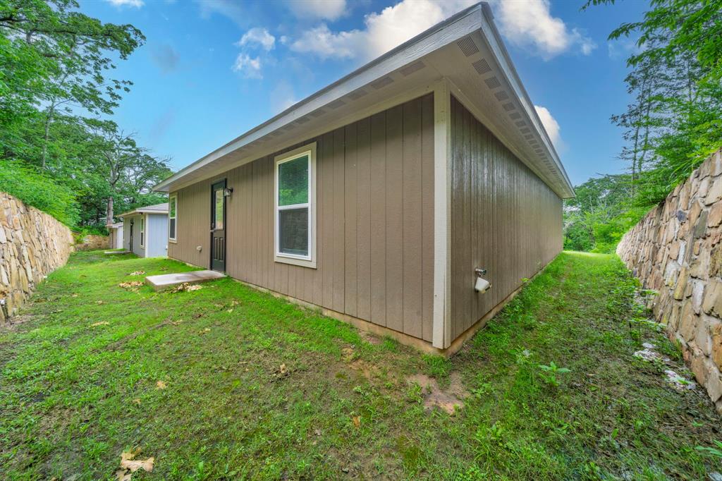 514 East Shepherd Street Denison, TX 75021 - Photo 15 of 16 a view of backyard with potted plants and large tree