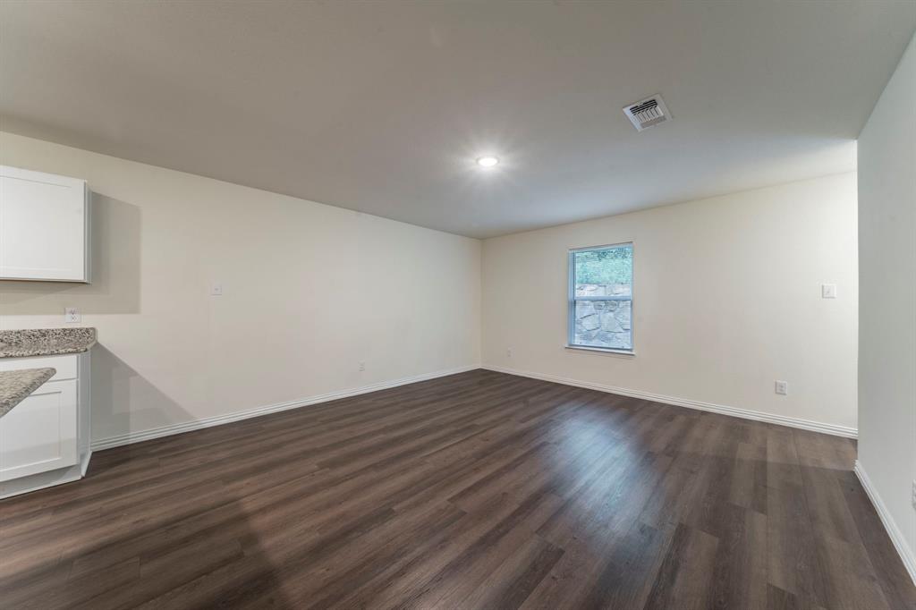 514 East Shepherd Street Denison, TX 75021 - Photo 3 of 16 an empty room with wooden floor and windows