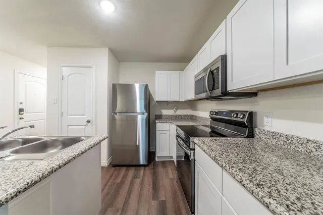 a kitchen with a sink stove and refrigerator