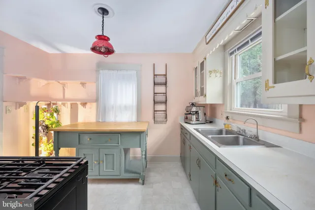 a kitchen that has a sink and a stove