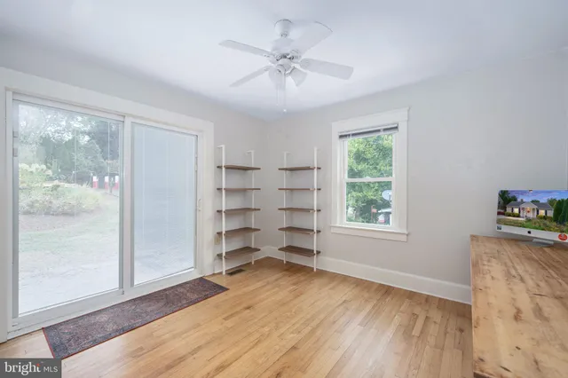 wooden floor in an empty room with a window