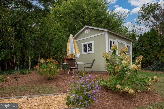 a front view of a house with a yard and sitting area