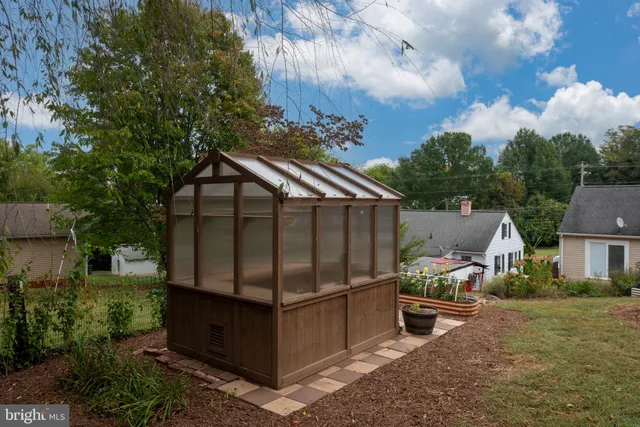 a view of a small yard with wooden fence