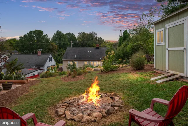 a view of backyard with outdoor seating and green space