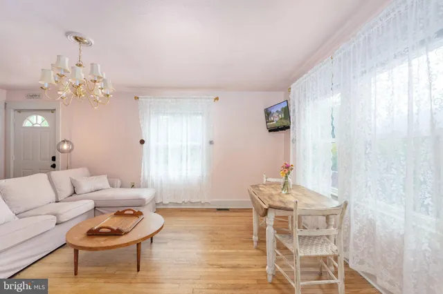 a living room with furniture and a chandelier