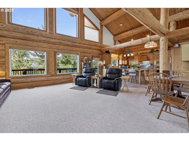 a bedroom with a bed wooden floor and large window