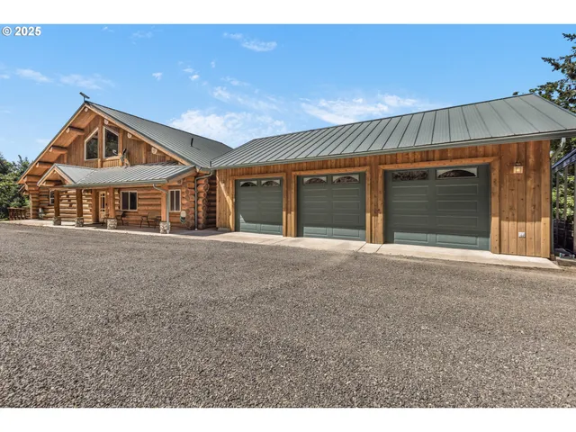 a view of an house with backyard and parking