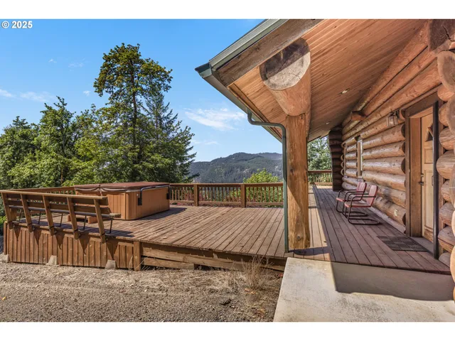 a view of balcony with wooden floor and fence