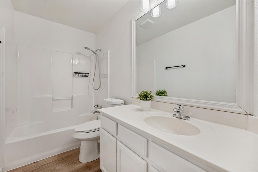 629 Concho Drive Oak Point, TX 75068 - Photo 25 of 35 a bathroom with a sink toilet and shower
