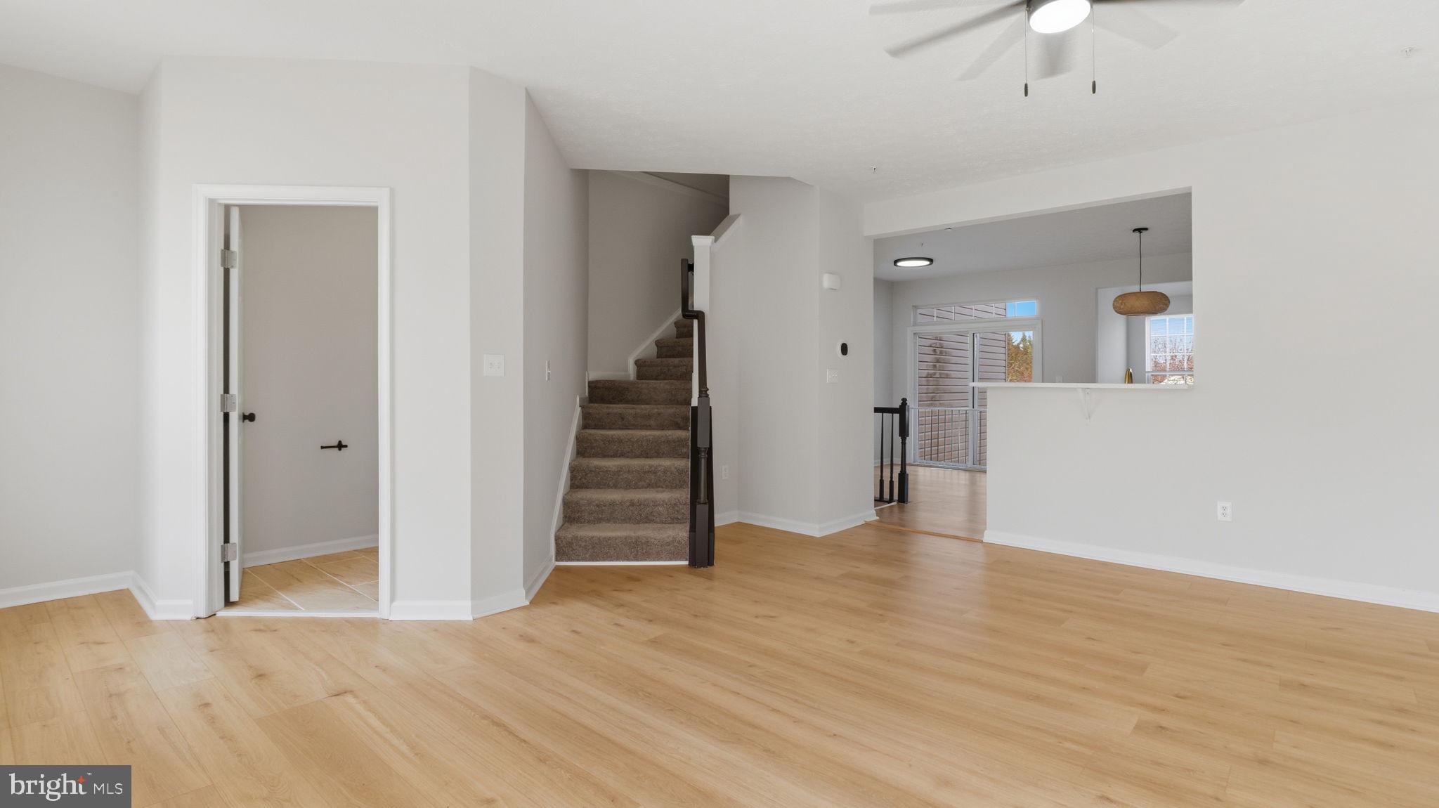 1404 Pangbourne Way Hanover, MD 21076 - Photo 10 of 31 a view of a hallway with wooden floor and staircase