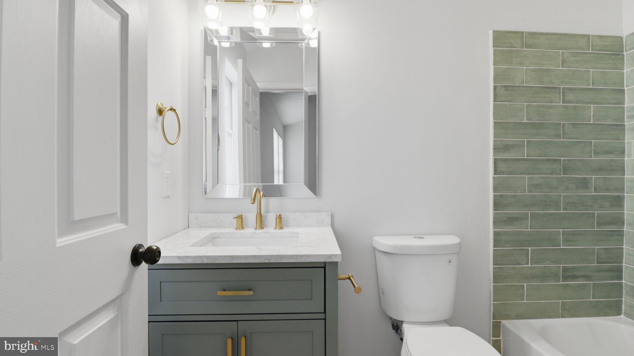 1404 Pangbourne Way Hanover, MD 21076 - Photo 15 of 31 a bathroom with a granite countertop toilet a sink and a mirror